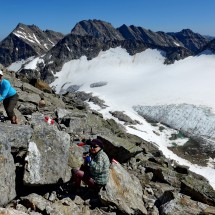 Two beautiful girls resting on the ridge to the summit of Sonnblick